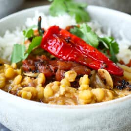 A bowl of chana dal with tadka and rice.