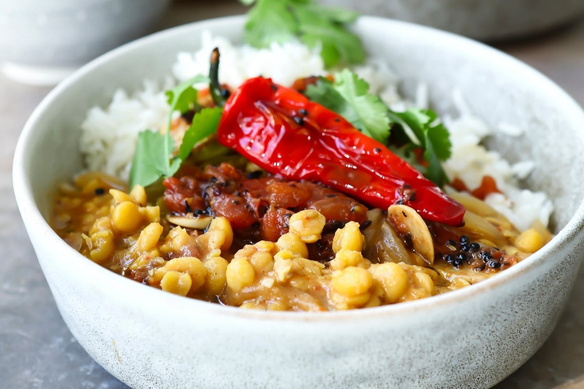 A bowl of chana dal with tadka and rice.