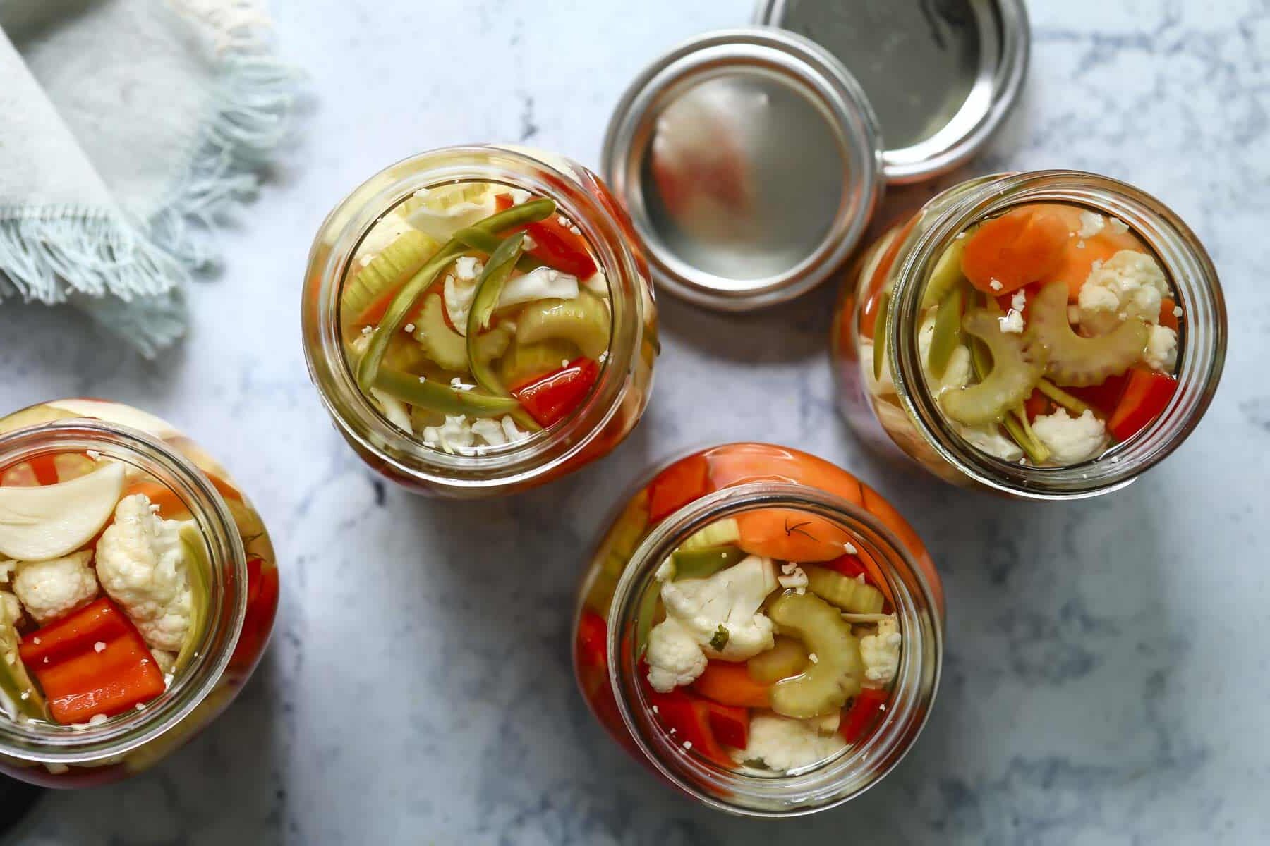 Four mason jars of Giardiniera.