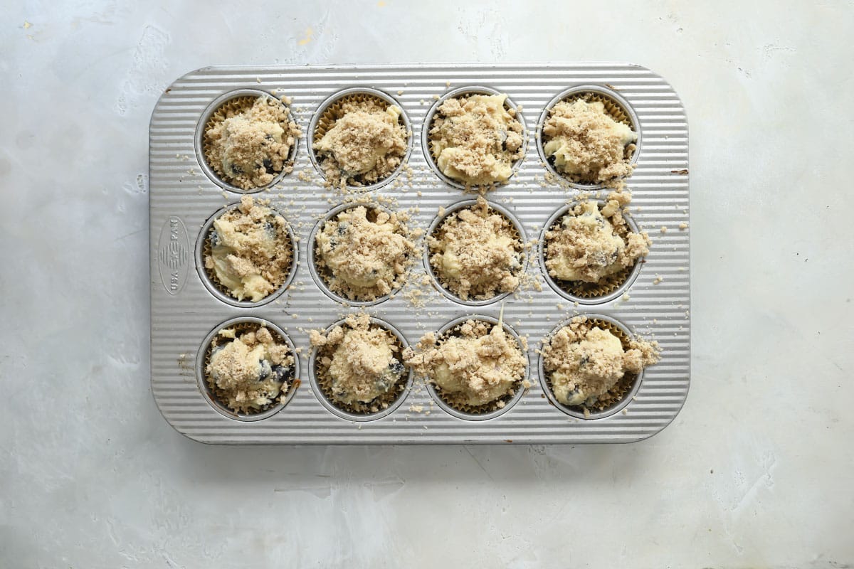 Batter for gluten-free muffins in a muffin tin before being baked.