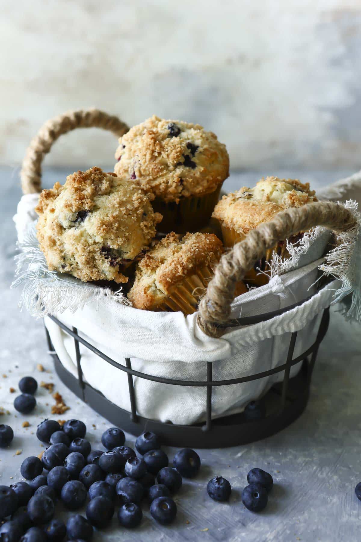 Gluten-free blueberry muffins in a metal basket.