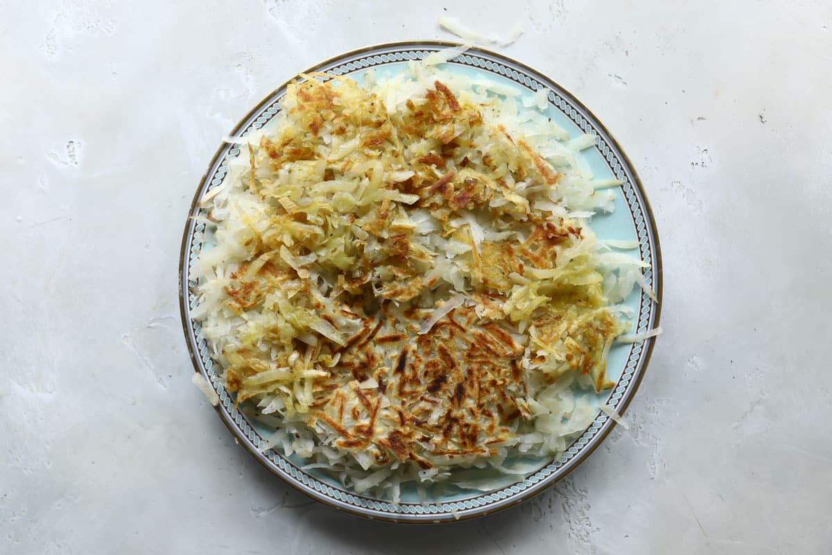 A platter of cooked hashbrowns.
