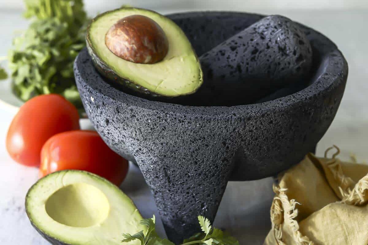 An avocado in a molcajete.
