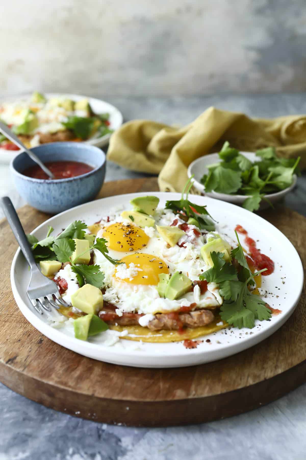 Two plates of Huevos Rancheros on a white plates.