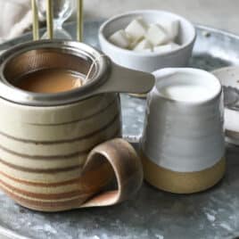 A cup of masala chai tea brewing.