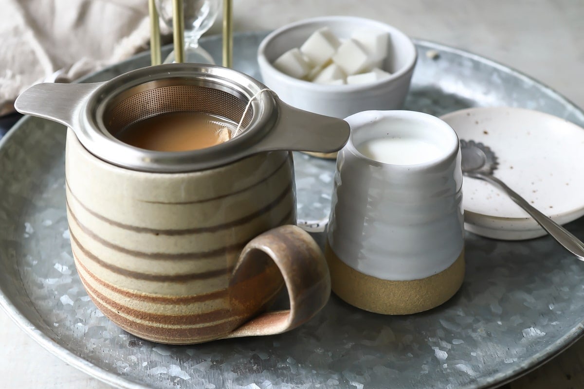A cup of masala chai tea brewing.