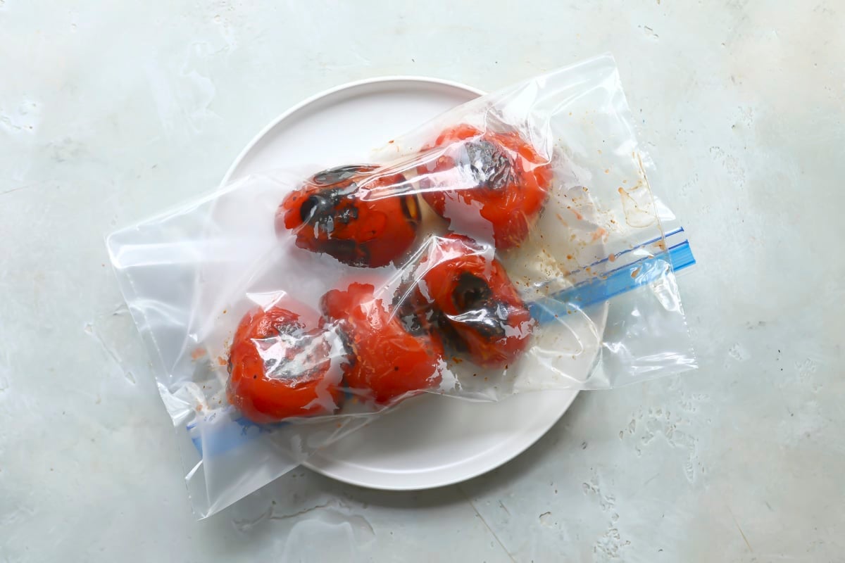 A zip top bag with roasted tomatoes in them.