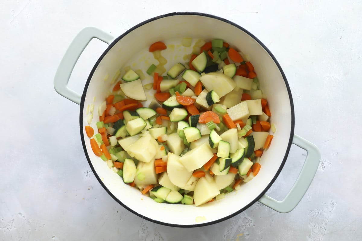Cubed vegetables in a Dutch oven.
