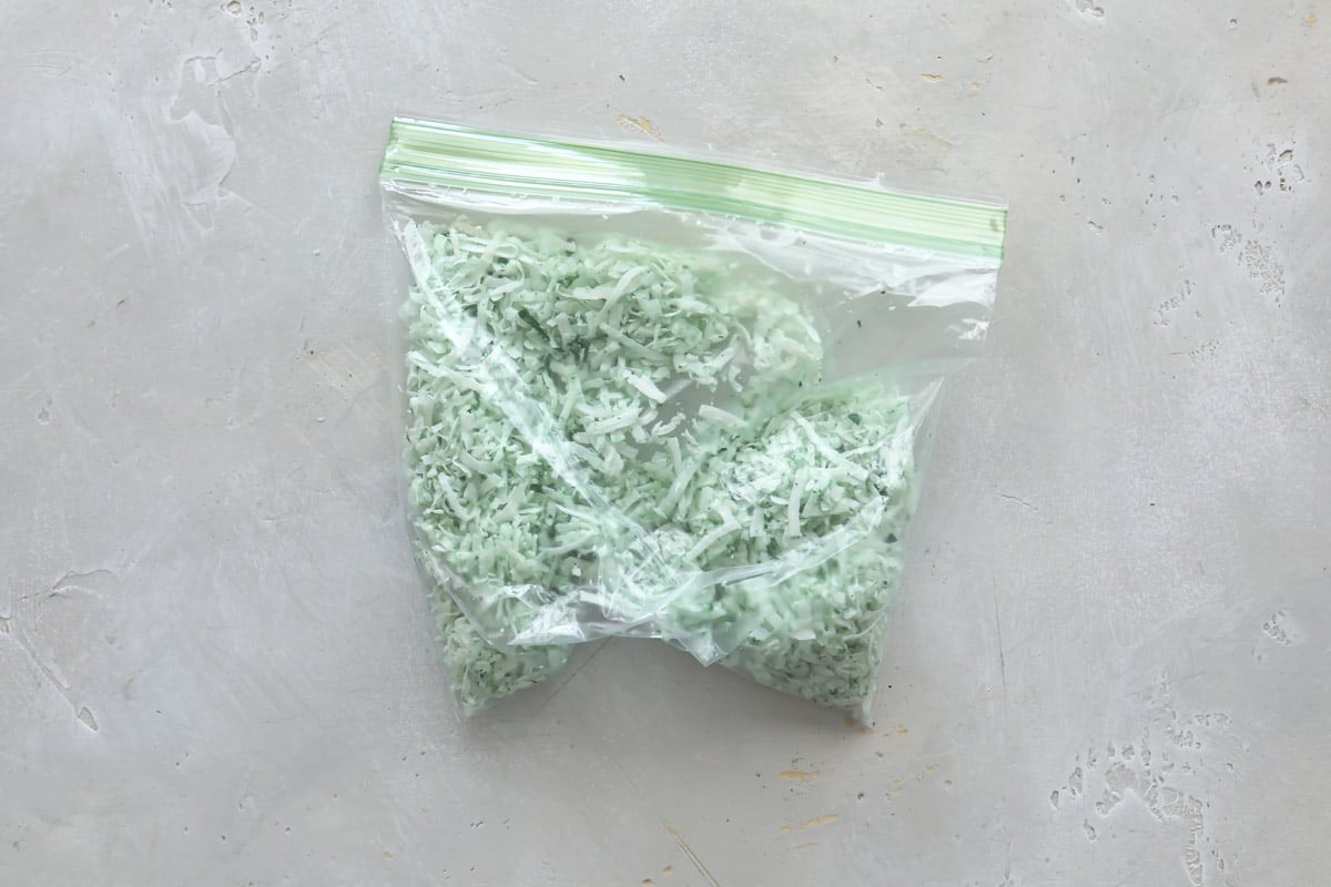 Shredded green coconut in a small zipper top bag.