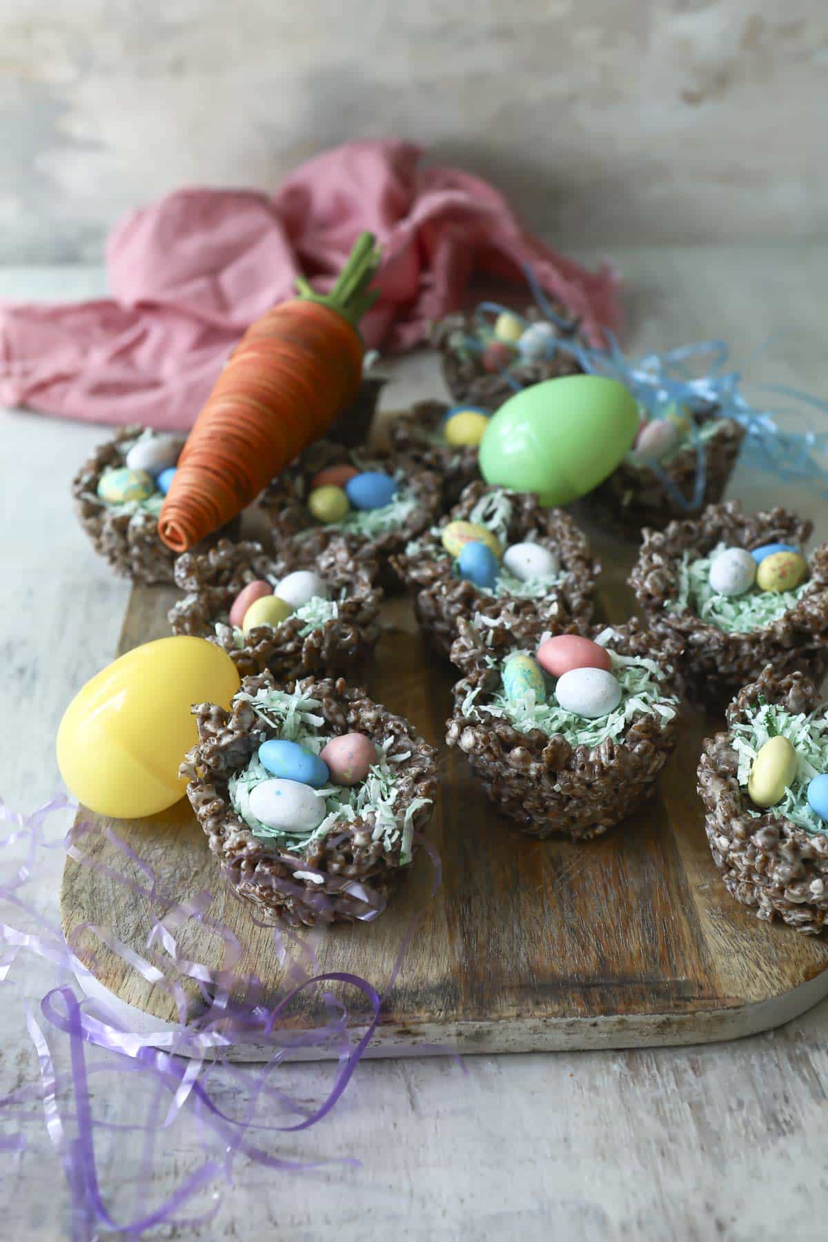 Easter rice krispie treats on a platter with plastic eggs.