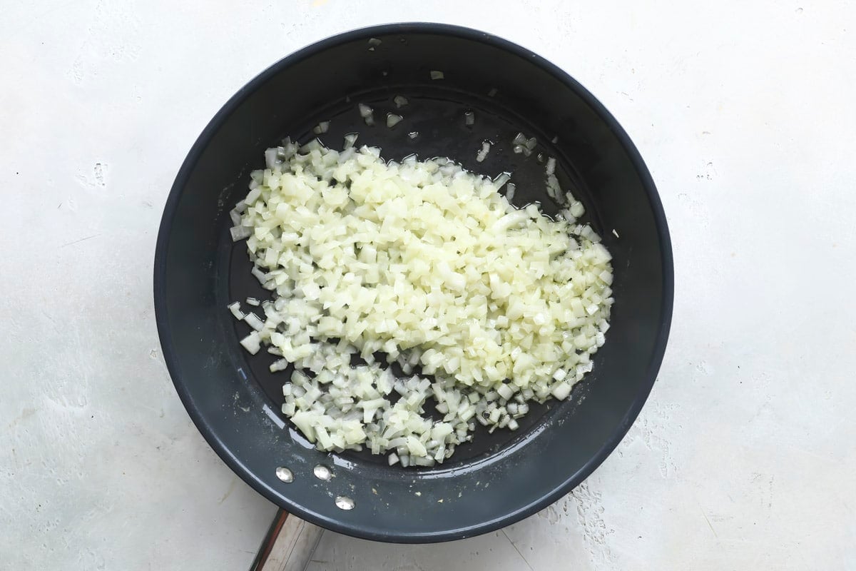 Cooking onions in a skillet.