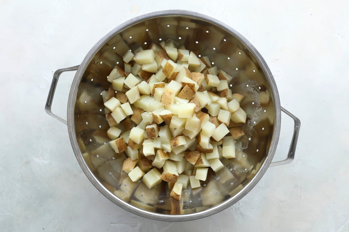 Draining cooked potatoes in a colander.