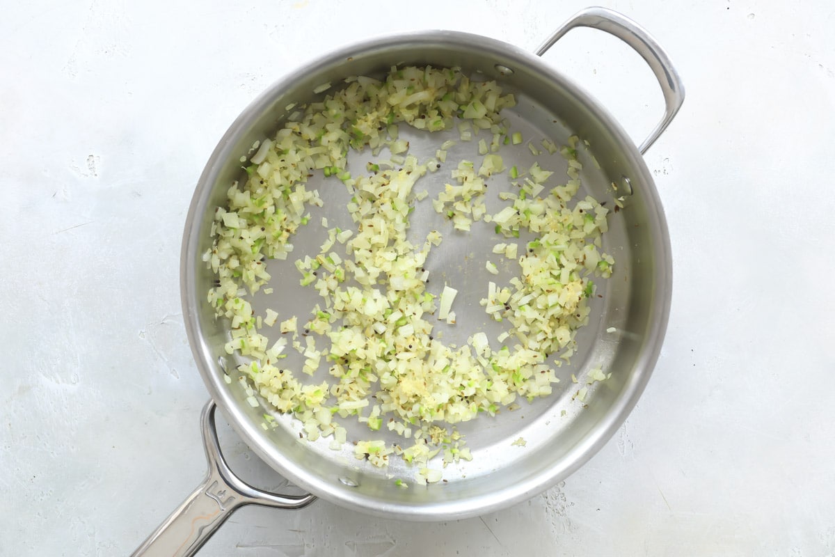 Cooking onions in a skillet.