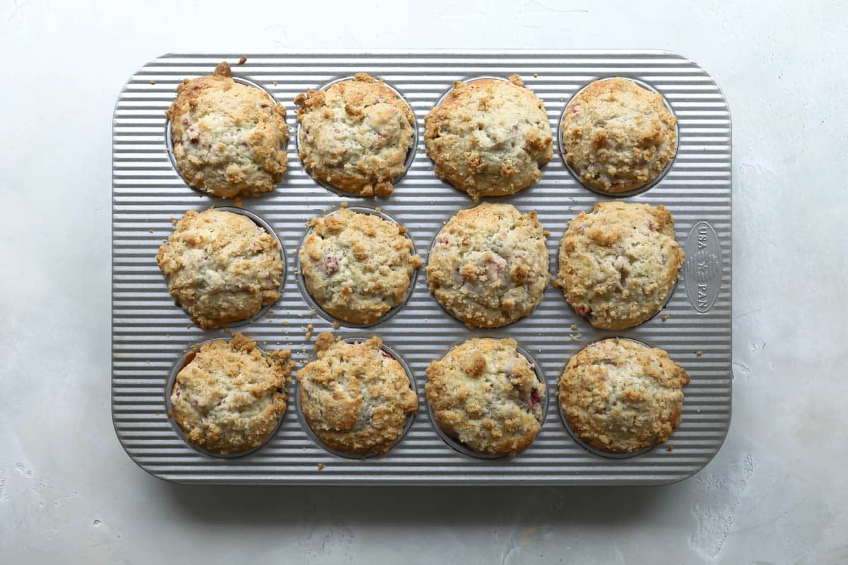 Baked raspberry muffins in a muffin tin.