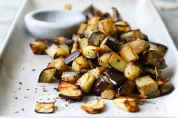 Air fryer eggplant on a white serving platter.