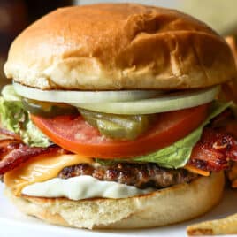 A bacon cheeseburger with french fries.