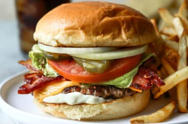 A bacon cheeseburger with french fries.