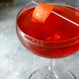 A Boulevardier Cocktail in a coupe glass.