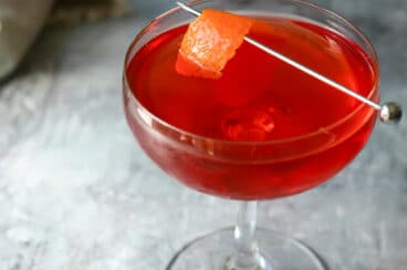 A Boulevardier Cocktail in a coupe glass.