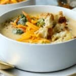 Broccoli cheese soup garnished with croutons and cheese.