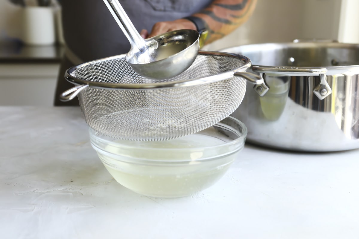 Straining broth for chicken soup.