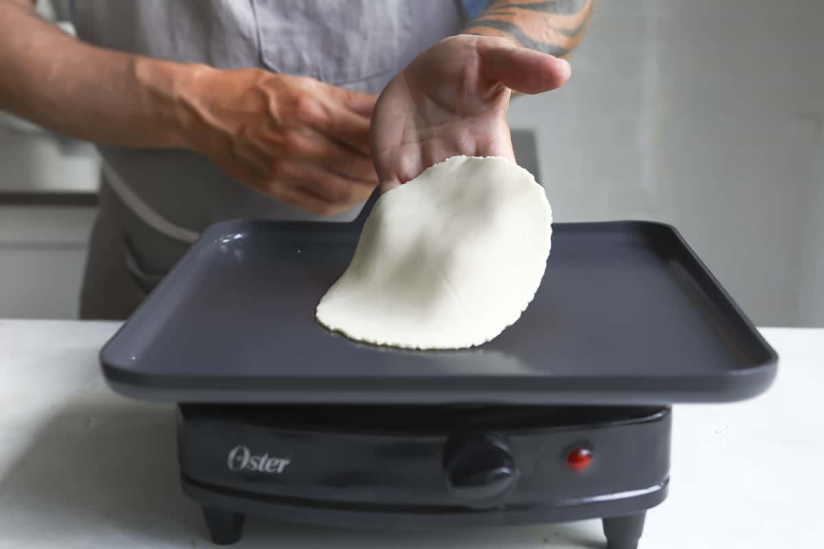 Tortillas cooking on a skillet.
