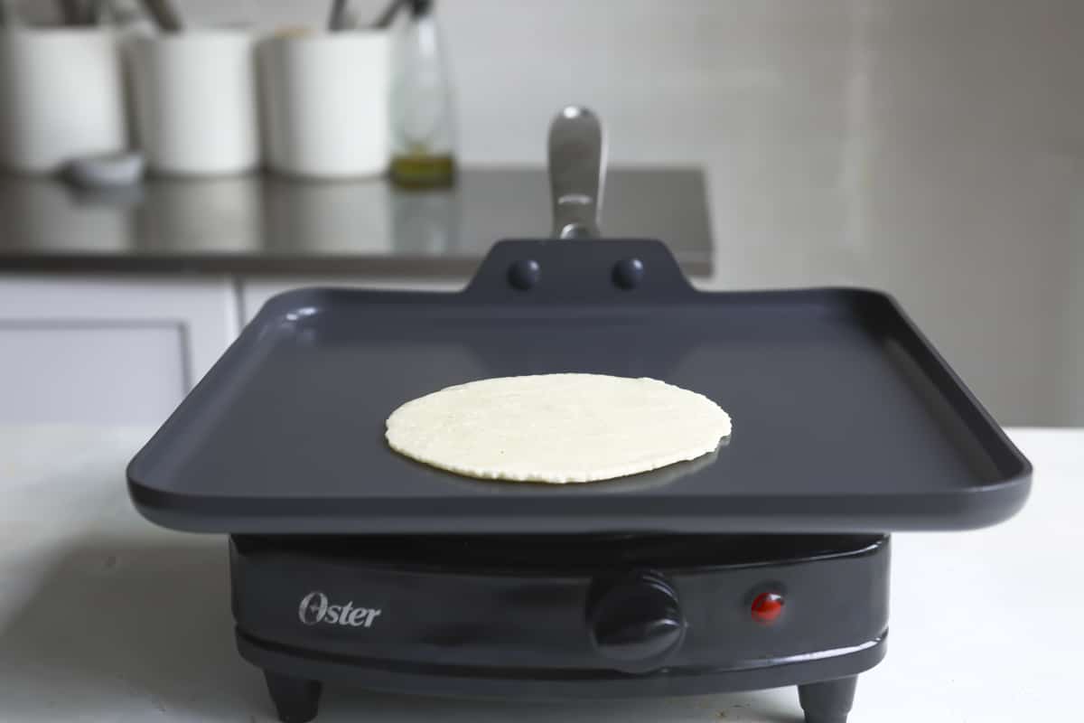 Tortillas cooking on a skillet.