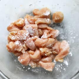 A bowl of chicken mixed with baking soda.