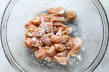 A bowl of chicken mixed with baking soda.