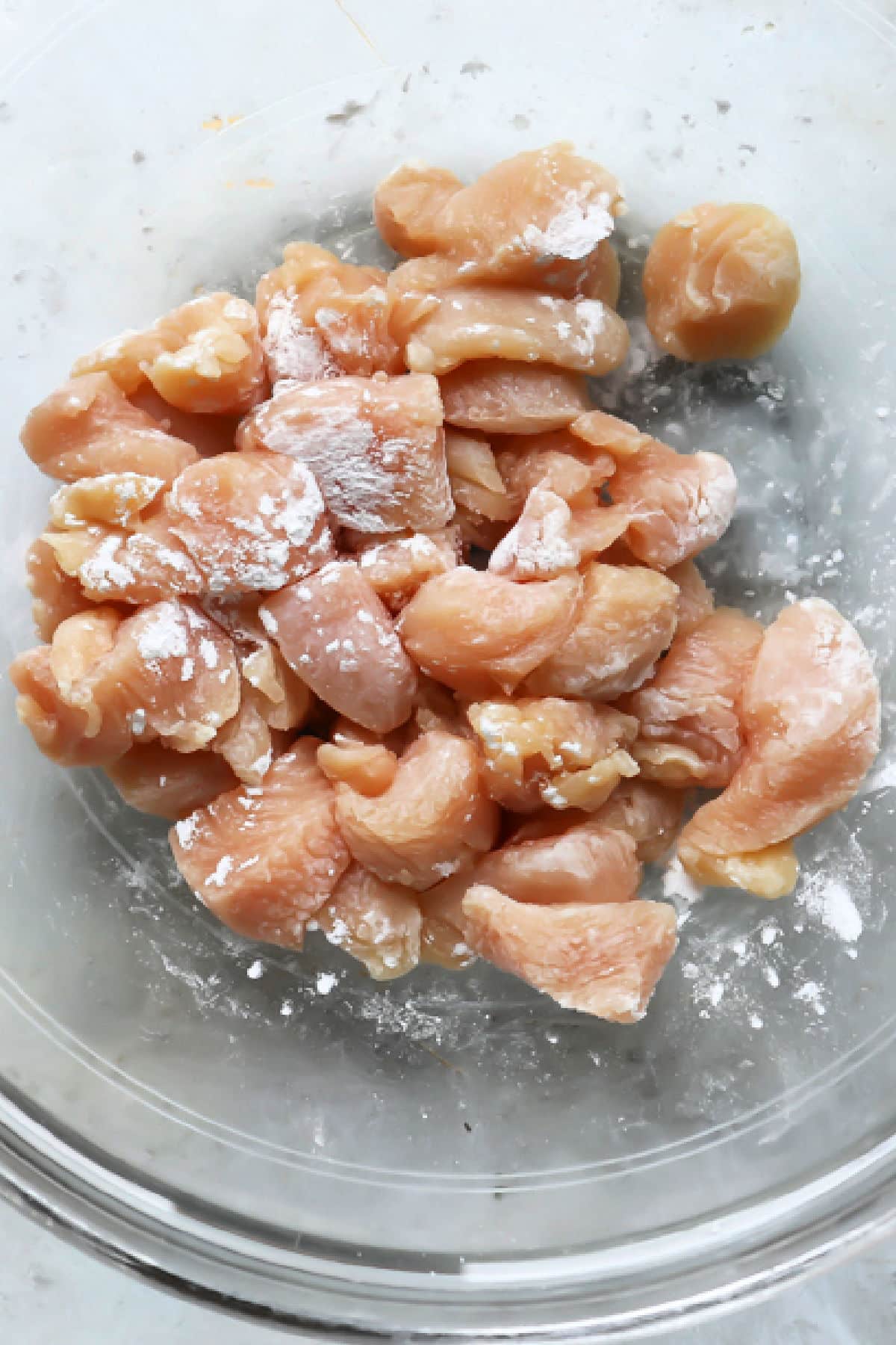 A bowl of chicken mixed with baking soda.