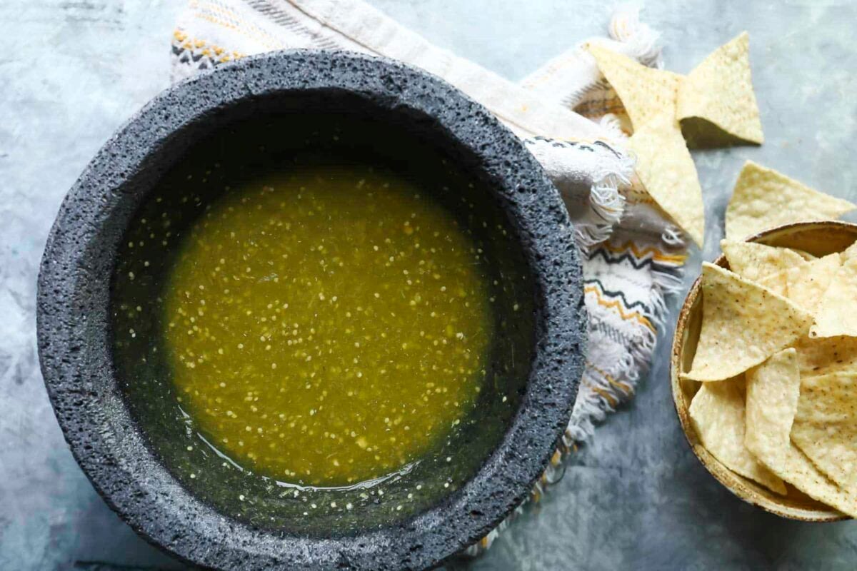A molcajete with salsa verde (green salsa) inside.