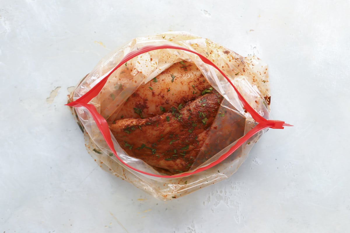 Chicken fajitas marinating in a plastic bag.
