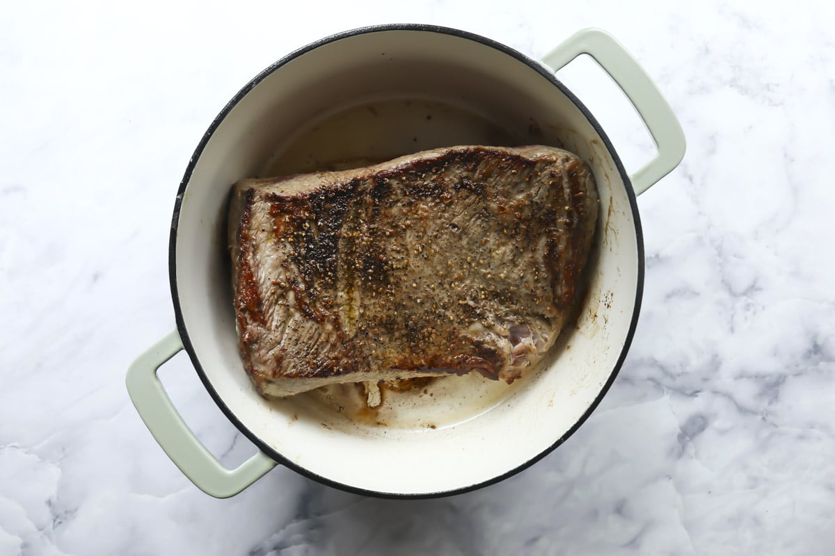 Searing a brisket in a Dutch oven.