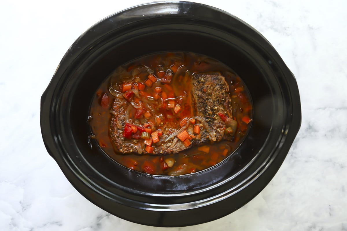 Slow cooker beef brisket in a crockpot after cooking.