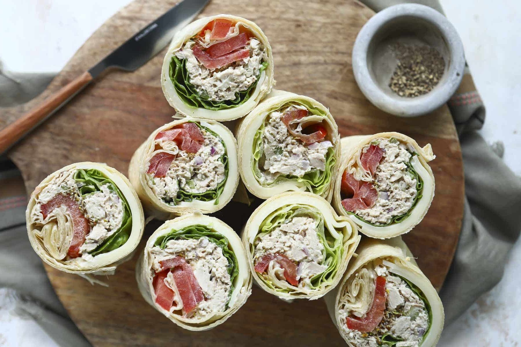Tuna wraps on a wooden serving platter.