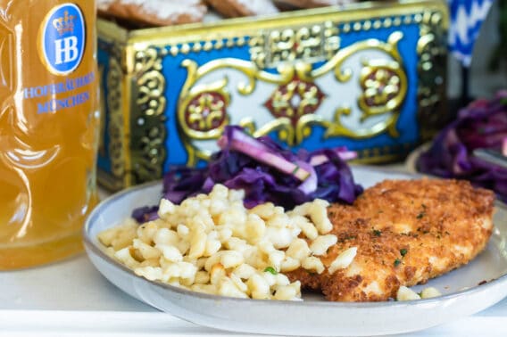 A table of Oktoberfest food including schnitzel, spaetzle, Lebkuchen, and beer.