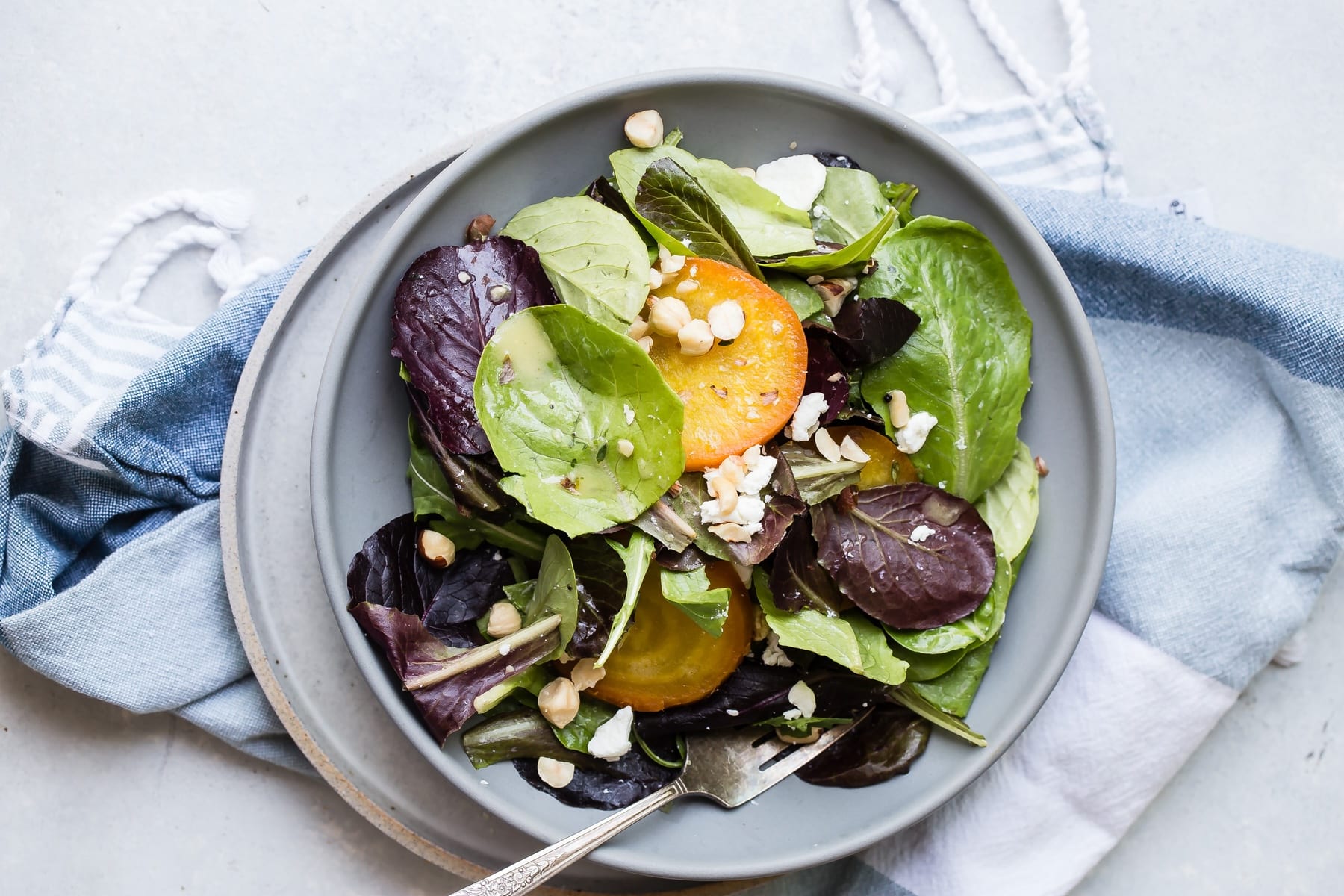 Beet salad in a grey bowl.