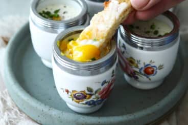 4 coddled eggs in individual coddlers.