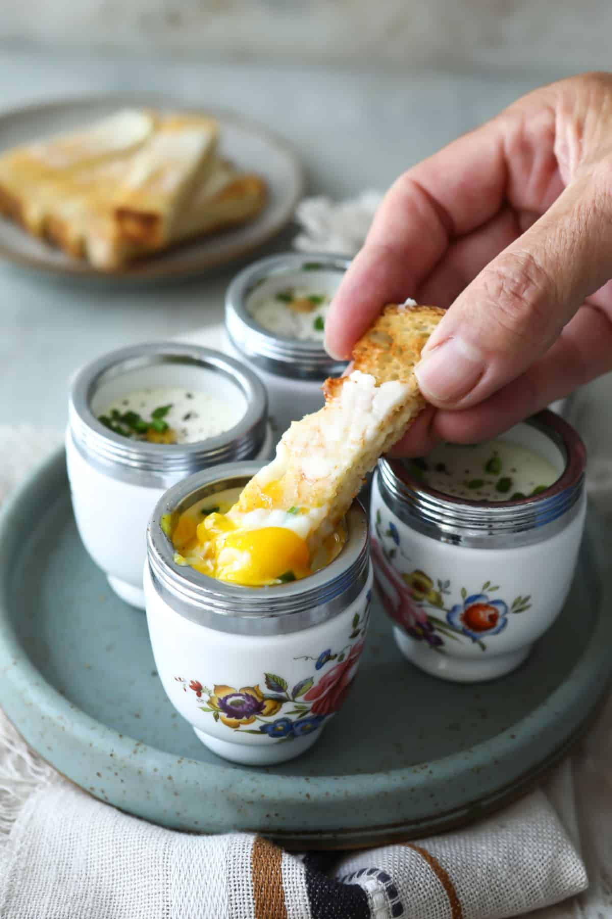 4 coddled eggs in individual coddlers.