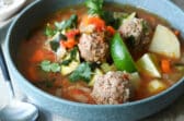 One blue bowls of Albondigas soup.