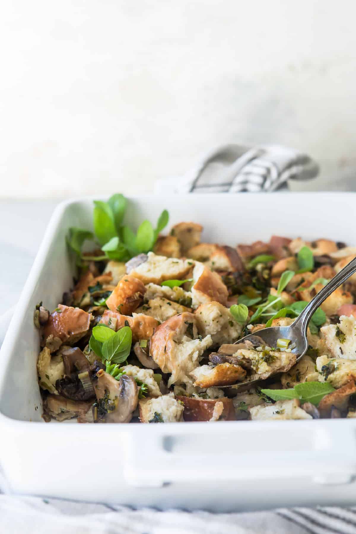 A white dish of vegan stuffing.