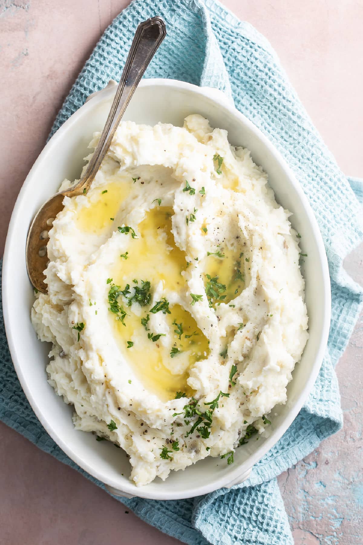 A dish of mashed potatoes with butter on top.