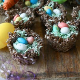 Easter rice krispie treats on a platter with plastic eggs.