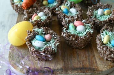 Easter rice krispie treats on a platter with plastic eggs.
