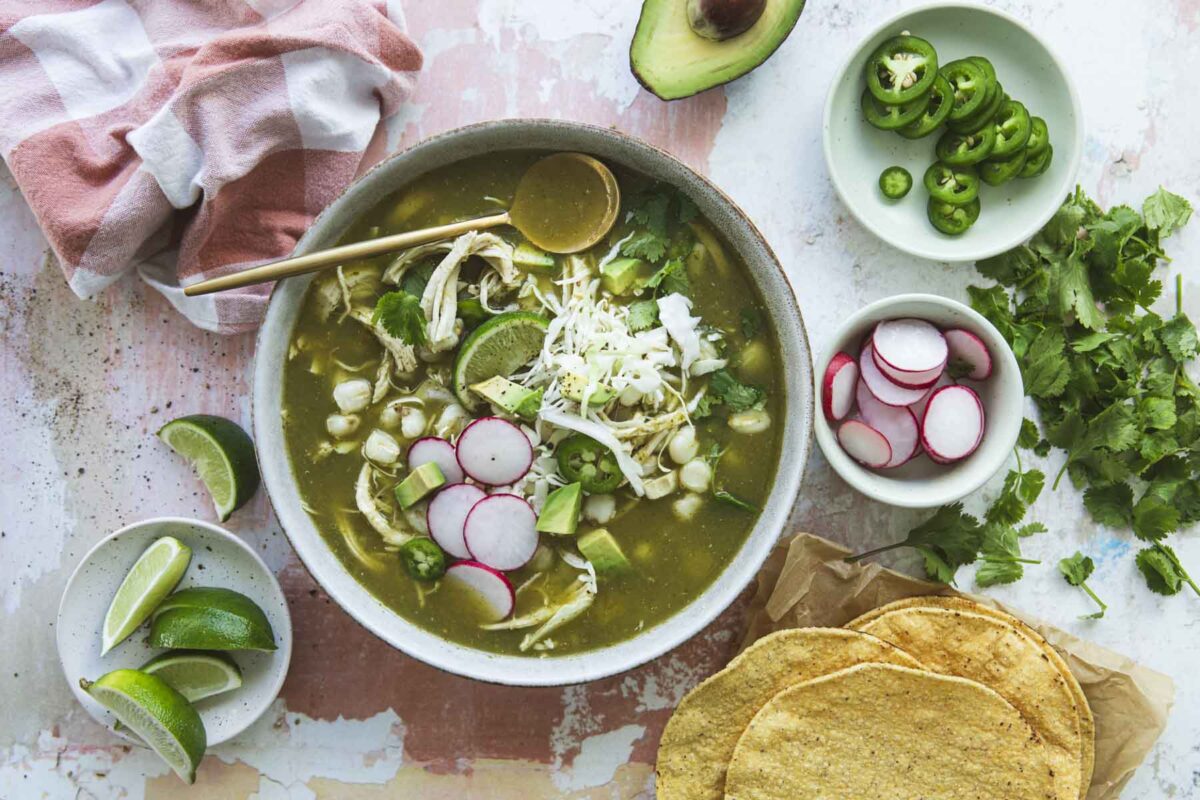 A bowl of pozole verde with toppings.