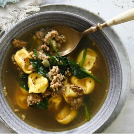 A bowl of sausage tortellini soup.