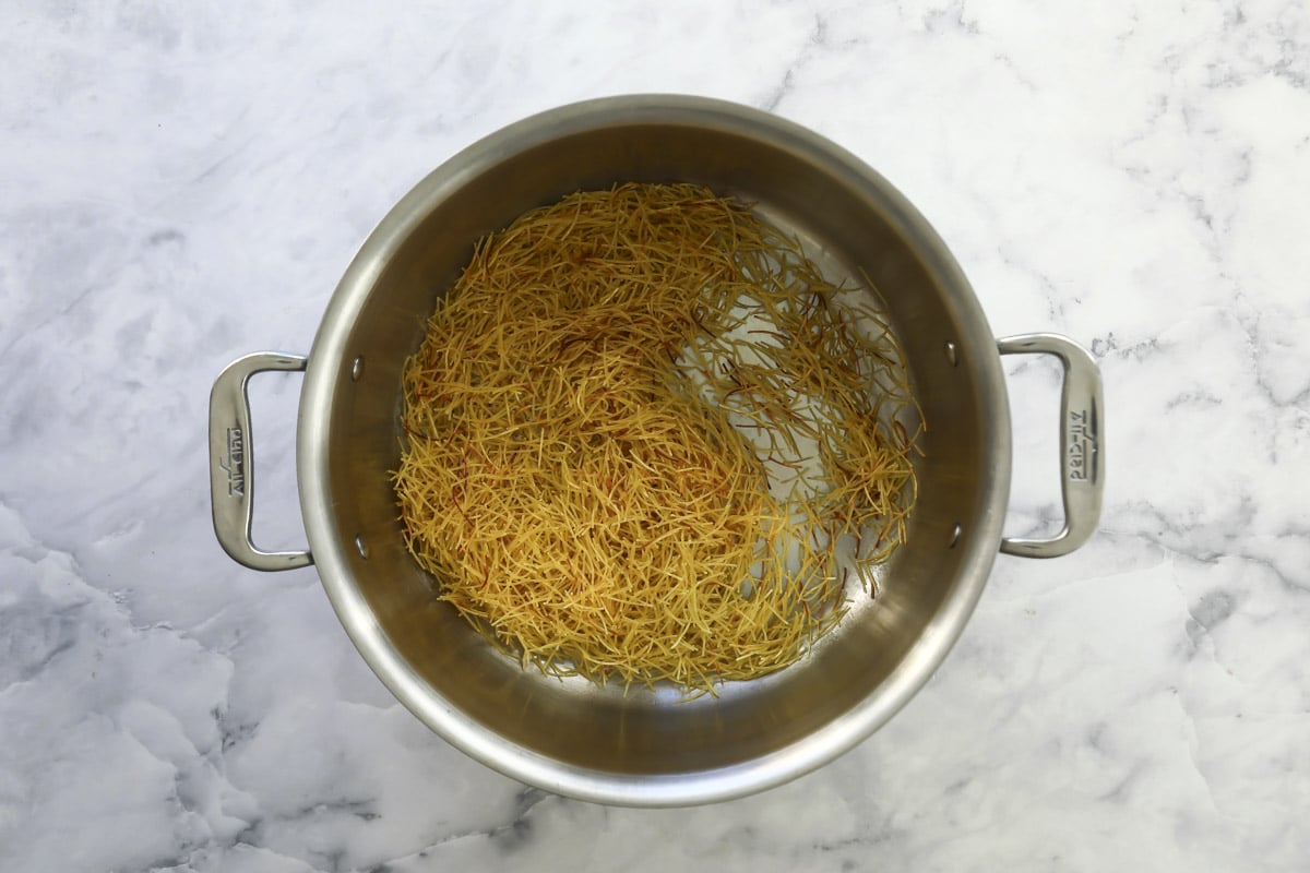 Toasting fideo noodles in a pot.