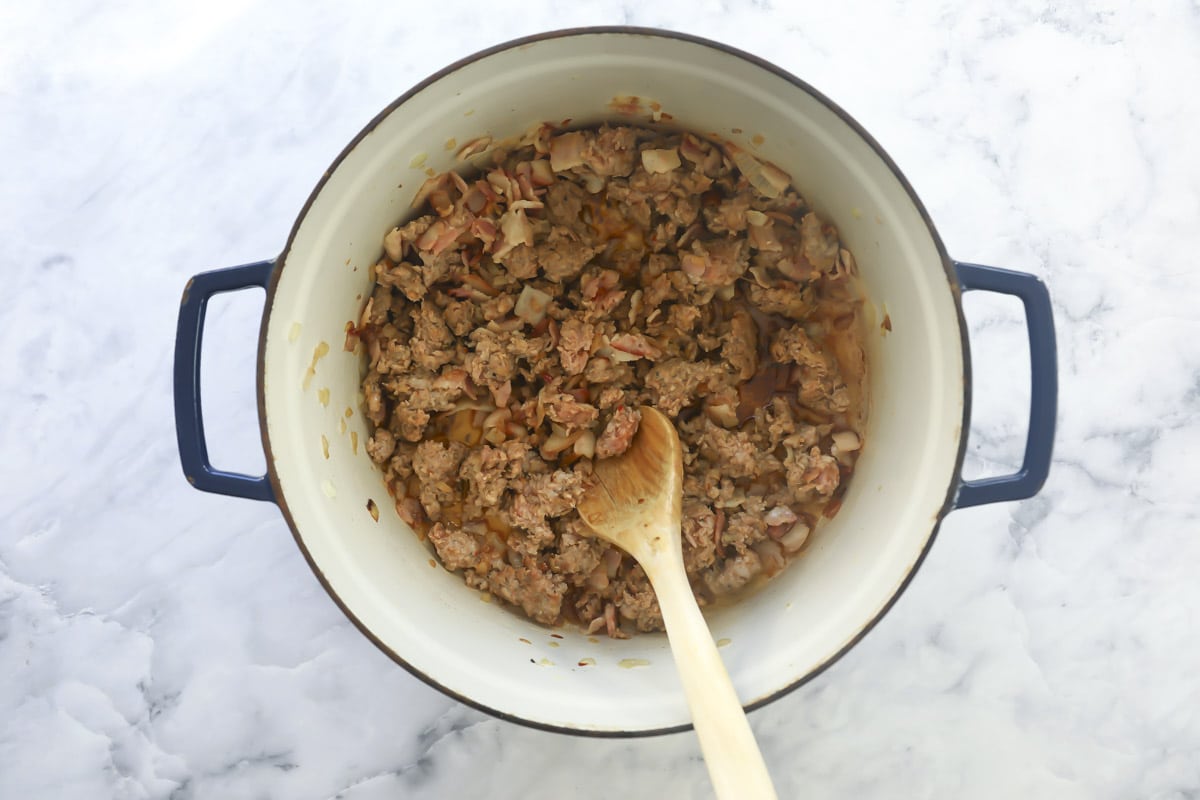 Sausage and vegetables cooking in a pot.
