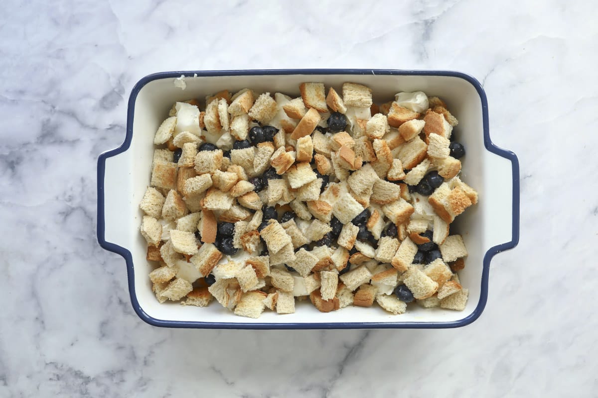 An unbaked dish of blueberry French toast casserole.