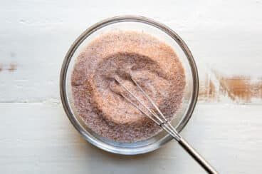 A bowl of homemade seasoned salt with a whisk.